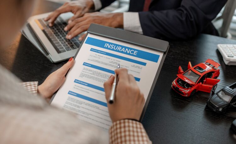 woman signing car insurance contract